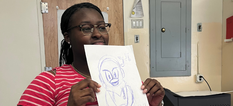 person holding up an image they drew