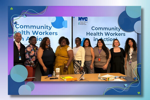 a group of chws standing for a picture in front of a banner that says community health workers in action